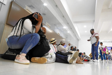 Personas descansan sobre sus maletas en el Aeropuerto Alfonso Bonilla Aragón, de Cali, a la espera de una solución para un vuelo con destino a la isla de San Andrés que fue cancelado por la aerolínea Ultra Air.