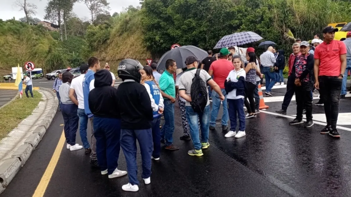 Delegados de la veeduría de Autopistas del Café, habitantes de Santa Rosa y Chinchiná, y estudiantes del colegio Eduardo Gómez Arrubla bloquen la vía entre Pereira y Manizales. 