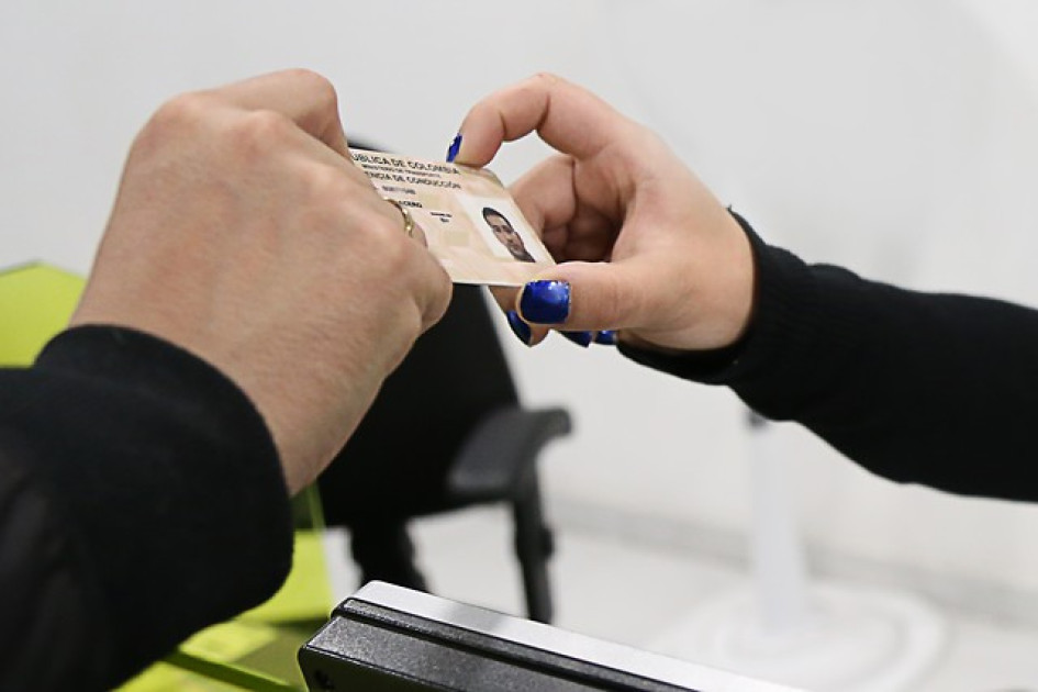 Estos-son-los-tipos-de-licencia-de-conduccion-en-Colombia Mano masculina y otra femenina sostienen una licencia de conducción.